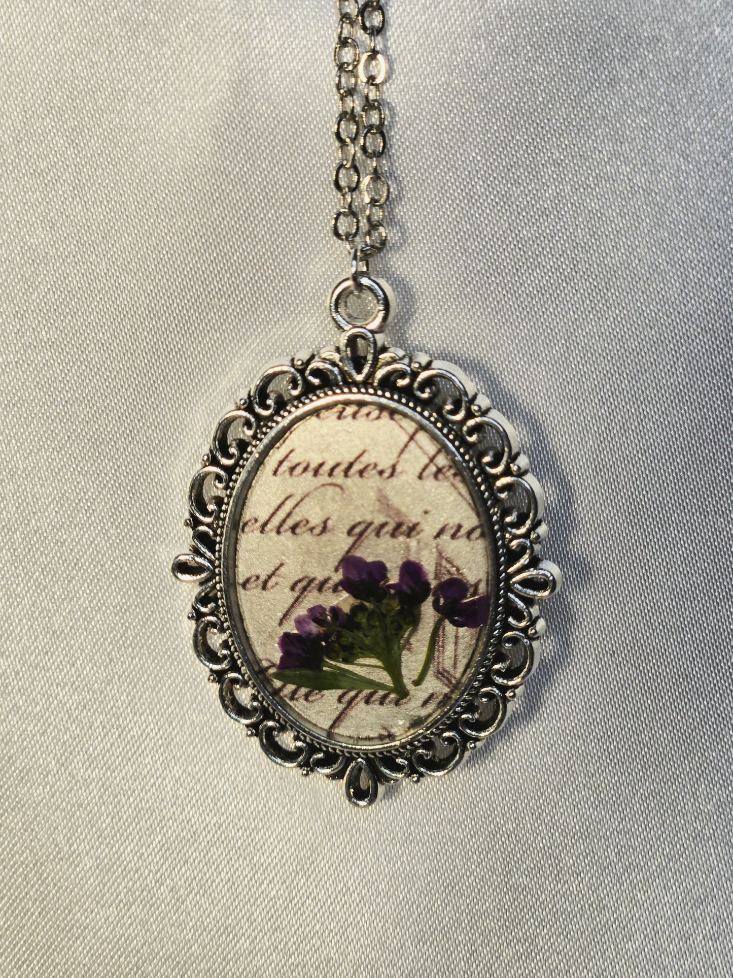 Vintage Floral Necklace with Real Purple Flowers and Script Background – Antique Style Oval Pendant – Botanical Jewelry Gift for Her